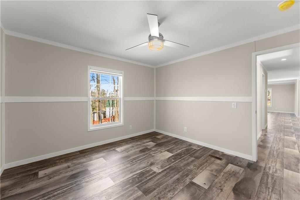 2410 Bolman Road Gainesville, GA 30507 - Photo 19 of 32 wooden floor in an empty room with a window