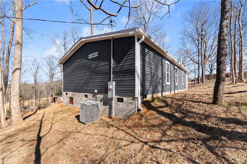 2410 Bolman Road Gainesville, GA 30507 - Photo 23 of 32 a backyard of a house with fire pit and chairs