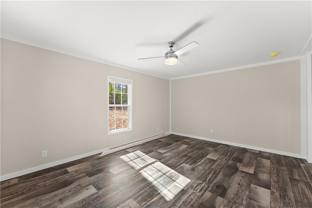 2410 Bolman Road Gainesville, GA 30507 - Photo 3 of 32 a view of empty room with wooden floor and fan