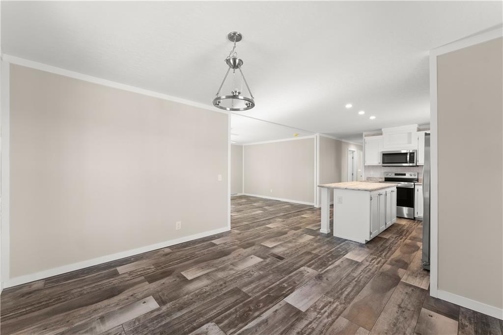 2410 Bolman Road Gainesville, GA 30507 - Photo 6 of 32 a view of a kitchen with a sink and dishwasher a refrigerator with wooden floor