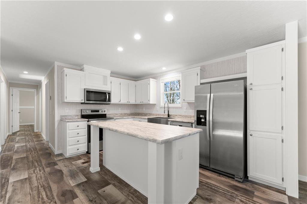 2410 Bolman Road Gainesville, GA 30507 - Photo 8 of 32 a kitchen with stainless steel appliances a refrigerator sink and microwave