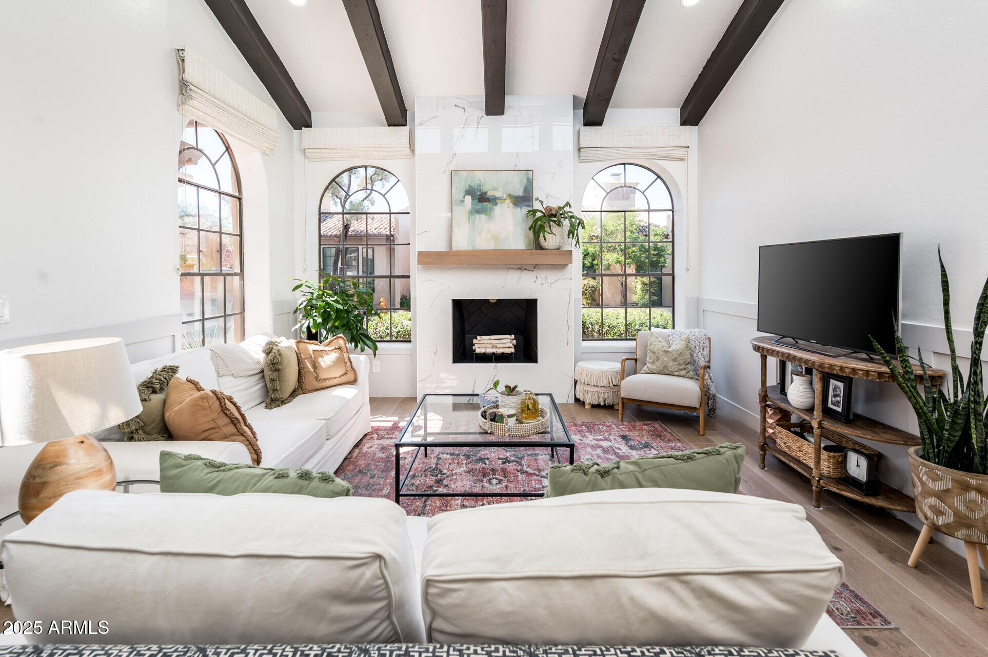 a living room with furniture fireplace and flat screen tv