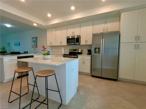 a kitchen with stainless steel appliances a refrigerator a stove a sink and a refrigerator