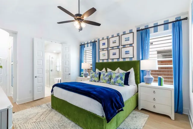 a bedroom with a large bed and a chandelier