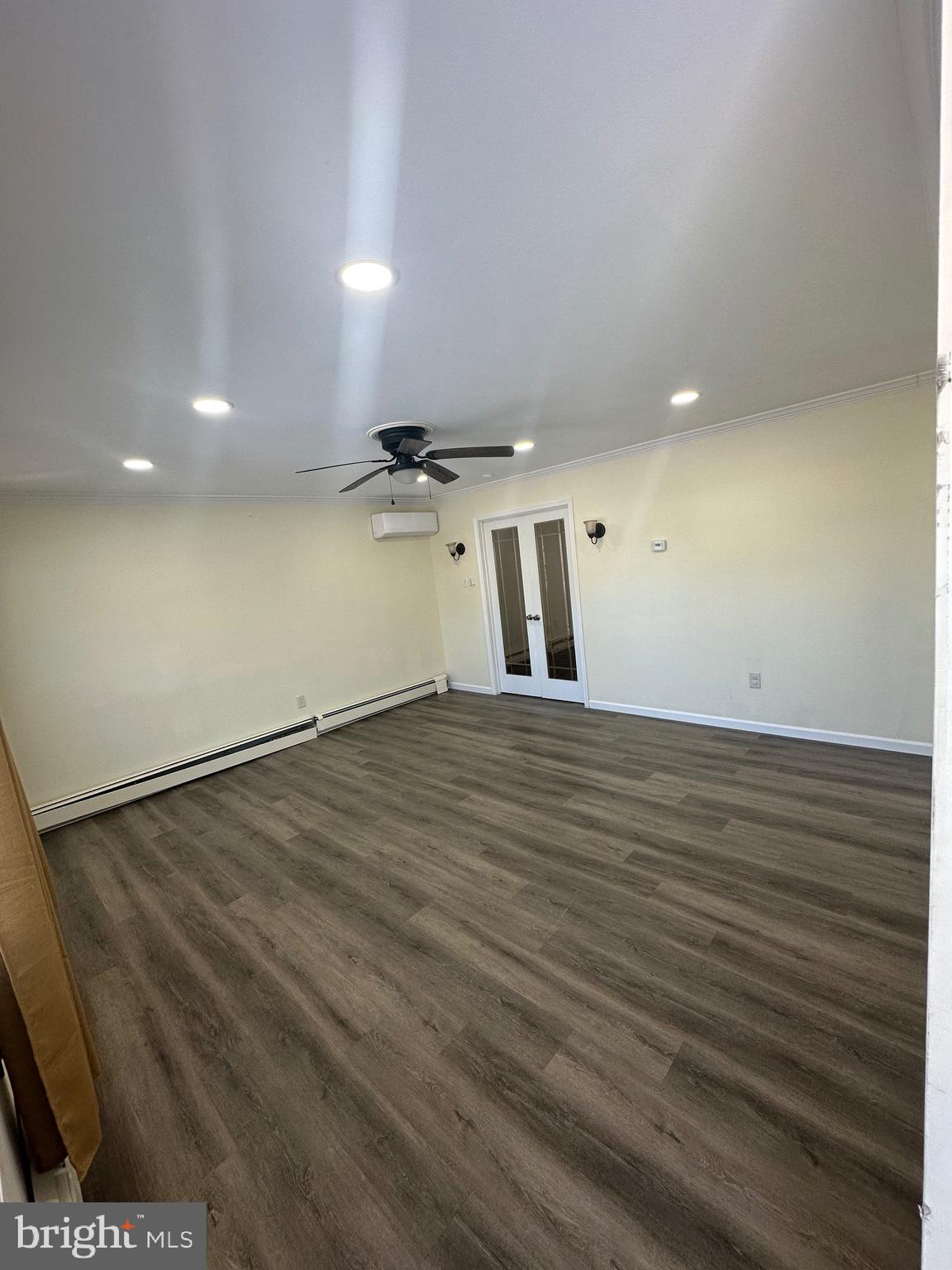 18 Victoria Lane Levittown, PA 19054 - Photo 11 of 19 an empty room with wooden floor and windows