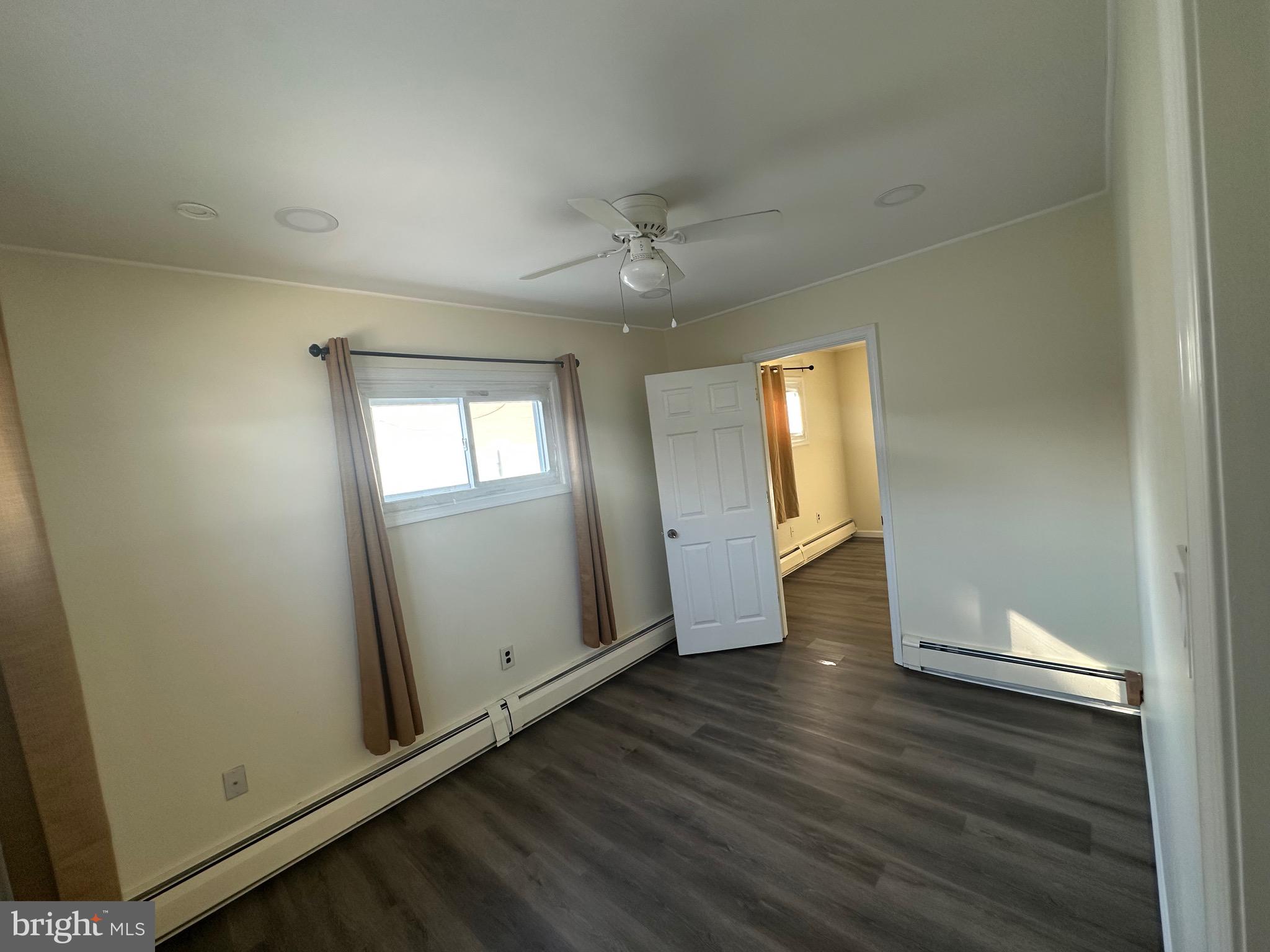 18 Victoria Lane Levittown, PA 19054 - Photo 14 of 19 an empty room with wooden floor and a window