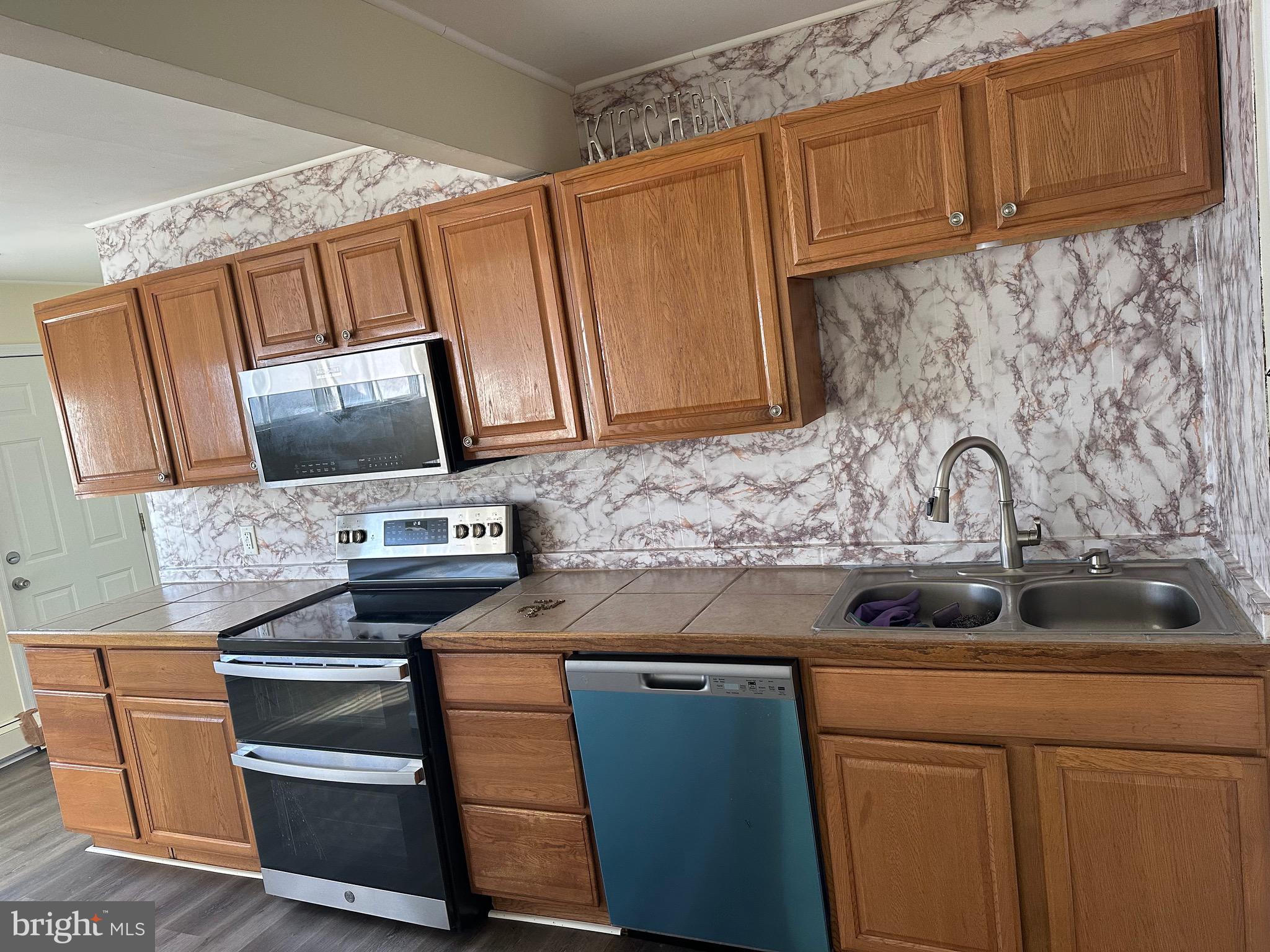 18 Victoria Lane Levittown, PA 19054 - Photo 2 of 19 a view of kitchen with stainless steel appliances granite countertop cabinets and a stove top oven