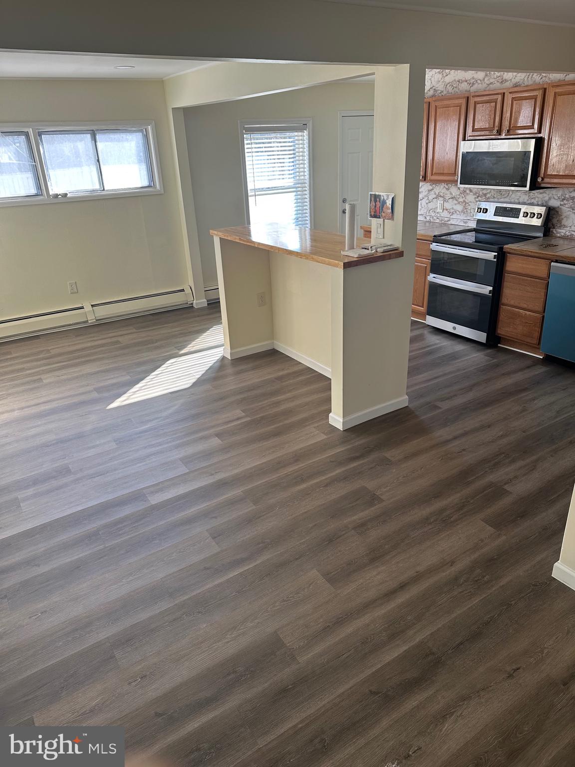 18 Victoria Lane Levittown, PA 19054 - Photo 4 of 19 a kitchen with a wooden floor and electronic appliances