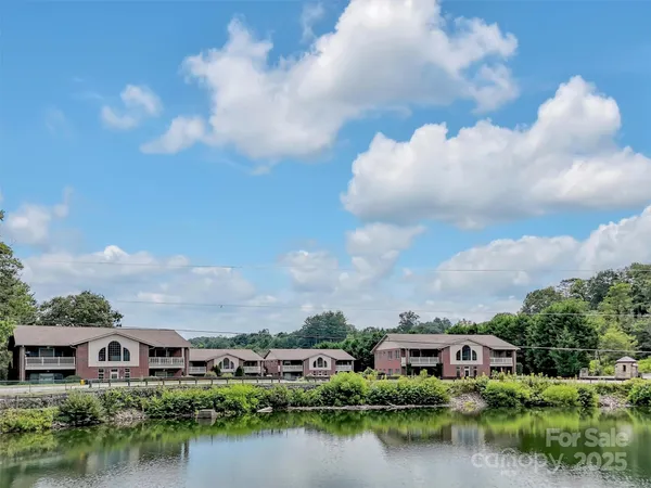 a view of a lake with houses in the back