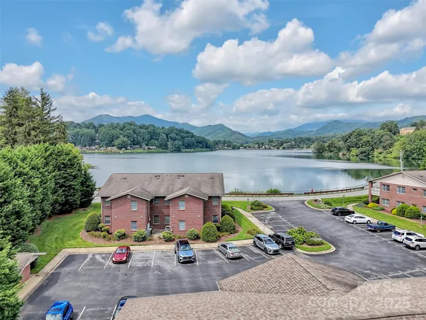 an aerial view of a house with a lake view