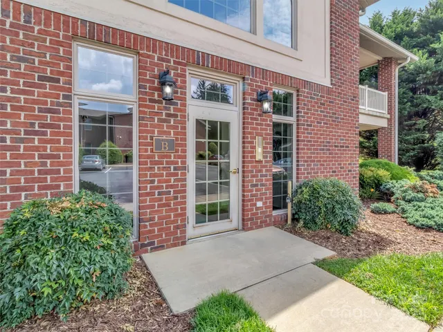 front view of a brick house with a large windows