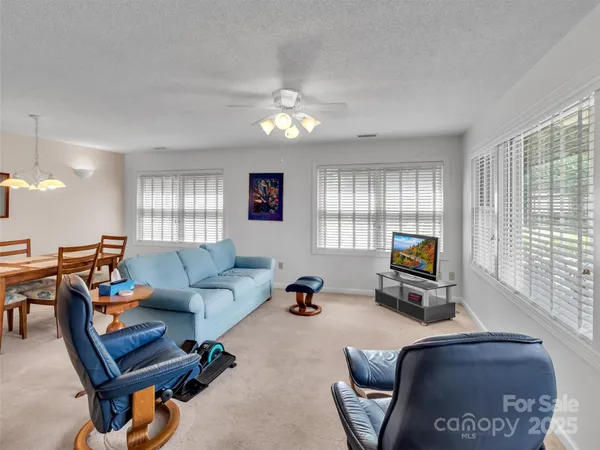 a view of a livingroom with workspace and a window