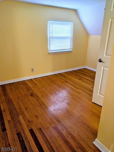 15 Friar Road Morris Plains, NJ 07950 - Photo 8 of 18 a view of an empty room with wooden floor and a window