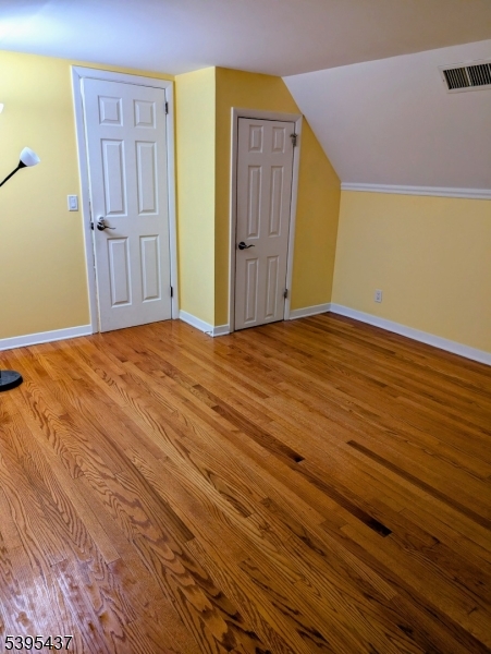 15 Friar Road Morris Plains, NJ 07950 - Photo 10 of 18 a view of an empty room with wooden floor and cabinet