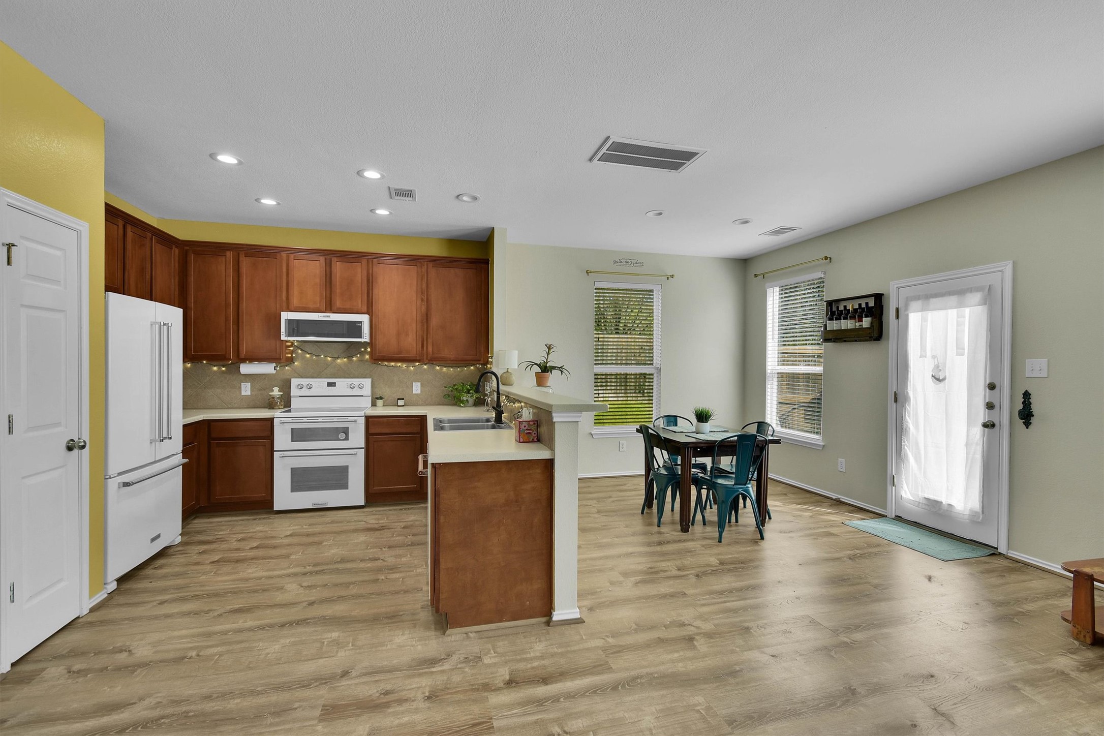 92 Verde Ranch Loop Leander, TX 78641 - Photo 11 of 37 a kitchen with a refrigerator and a dining table