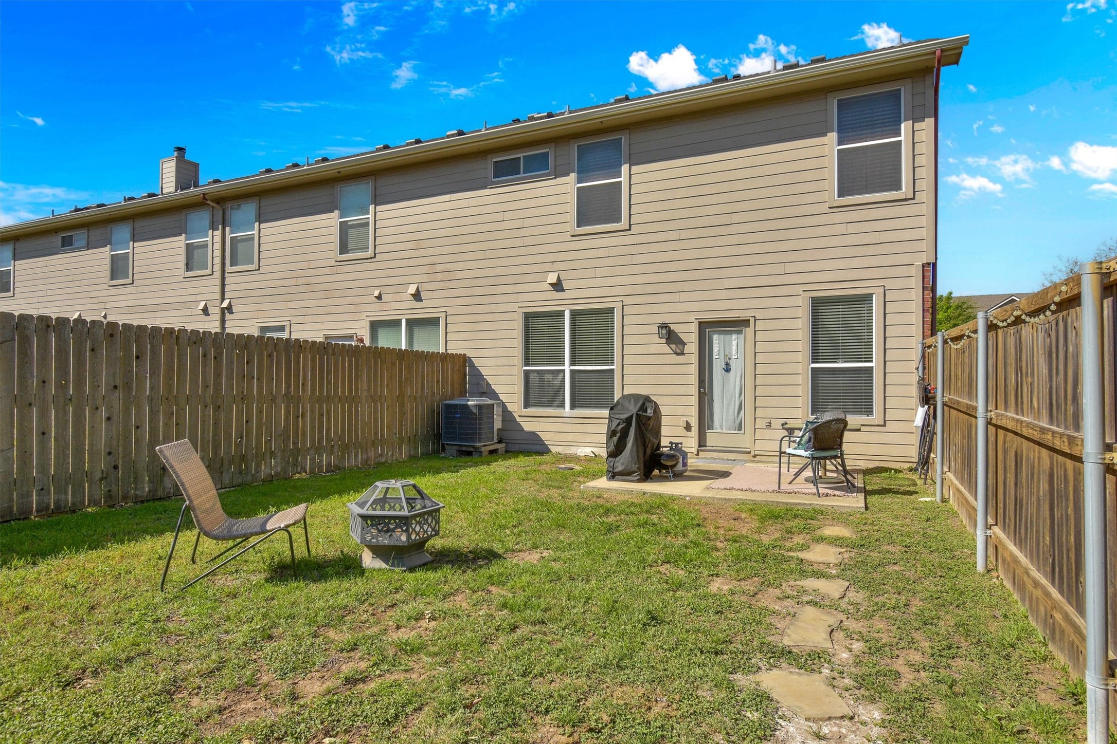 92 Verde Ranch Loop Leander, TX 78641 - Photo 25 of 37 a backyard of a house with table and chairs