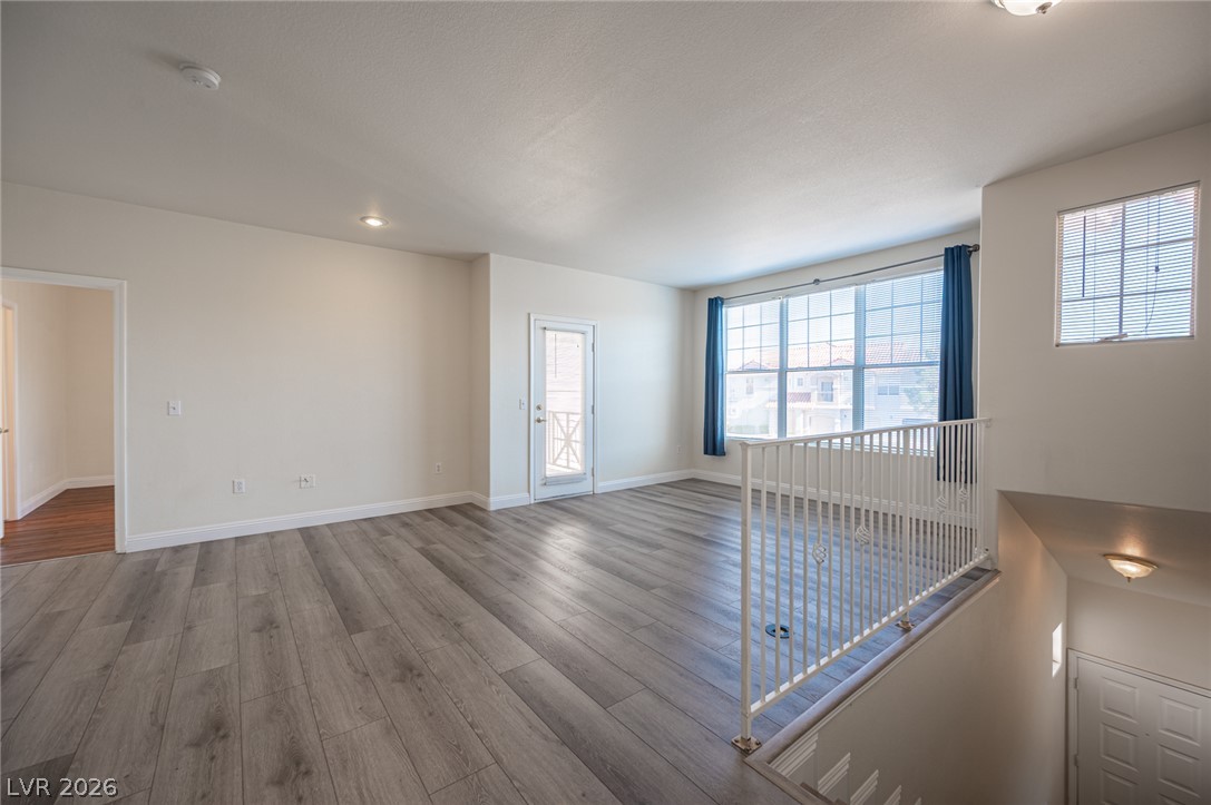 8555 West Russell Road, Unit 2062 Las Vegas, NV 89113 - Photo 5 of 35 Natural light floods this spacious living area featuring contemporary flooring and convenient access to patio.