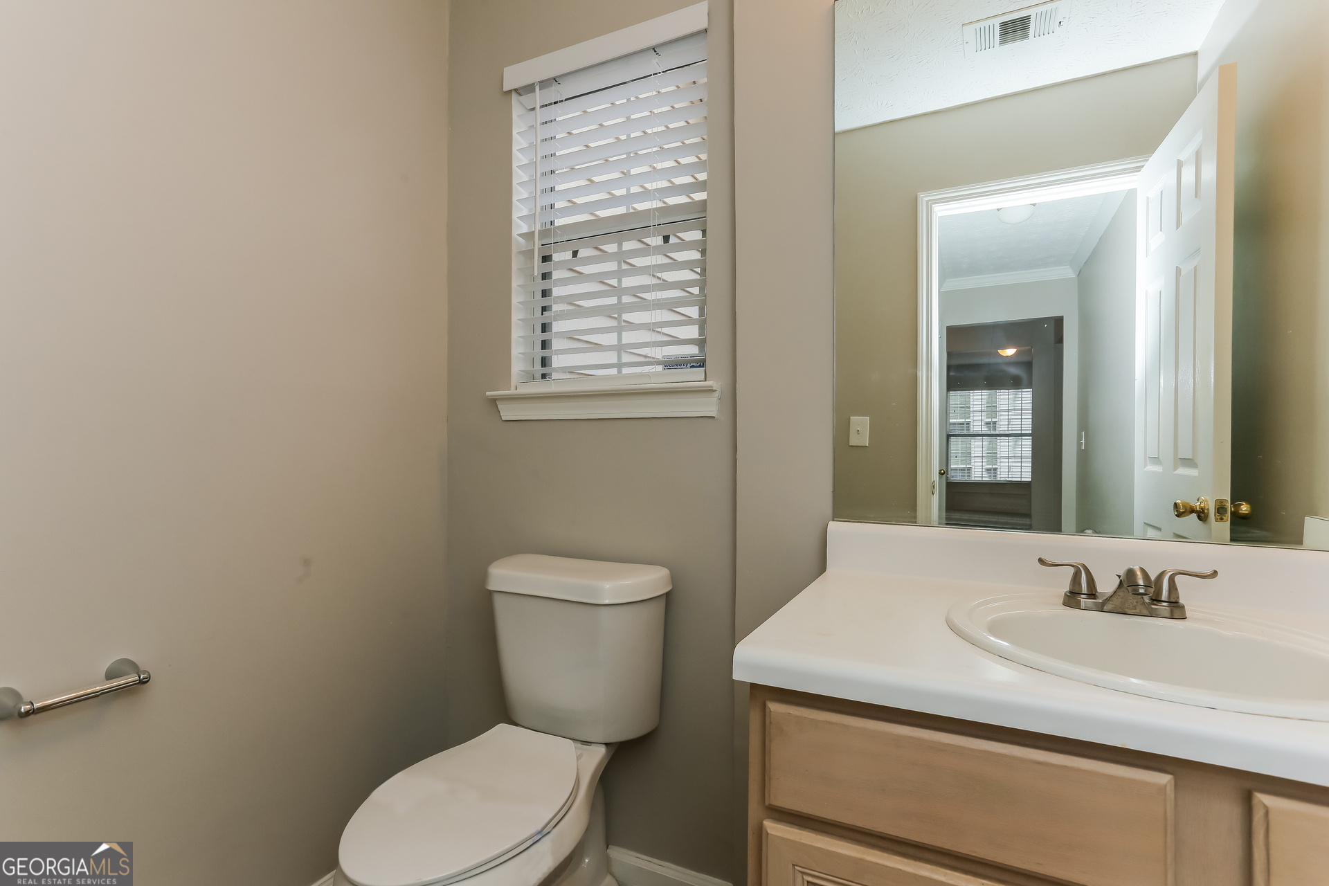 3797 Landgraf Cove Decatur, GA 30034 - Photo 14 of 17 a bathroom with a granite countertop toilet a sink and a mirror