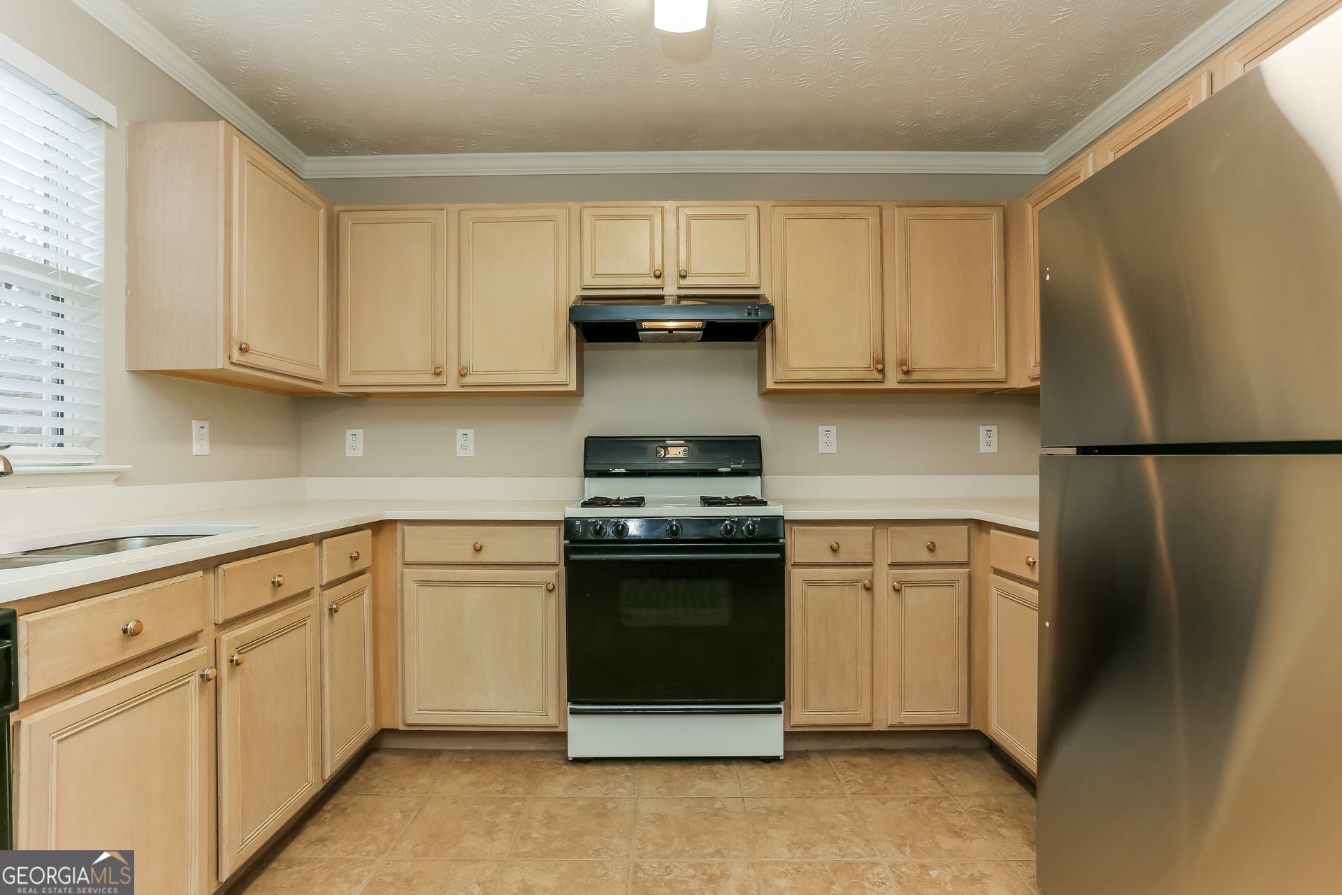 3797 Landgraf Cove Decatur, GA 30034 - Photo 5 of 17 a kitchen with stainless steel appliances granite countertop a stove a sink and a refrigerator