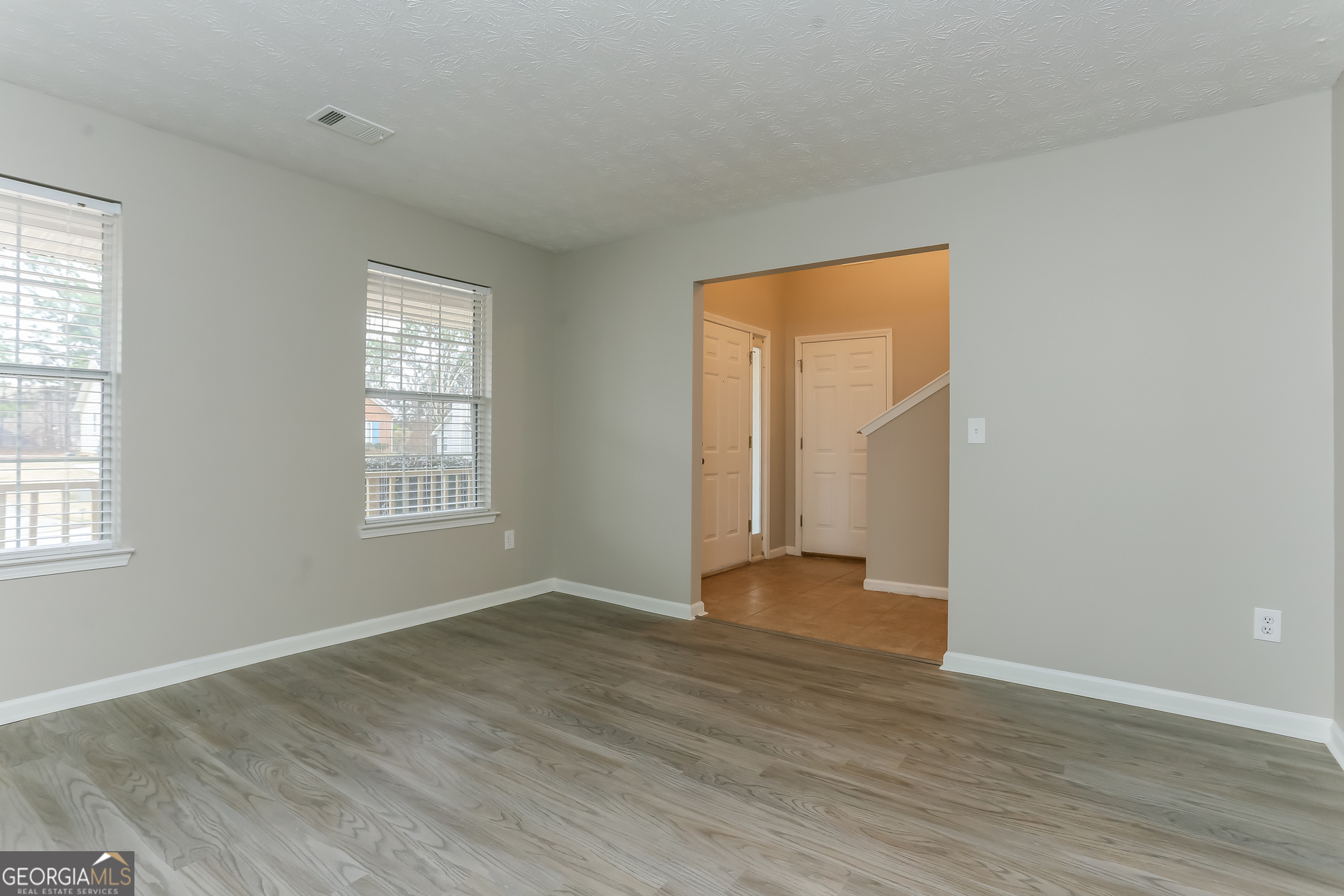 3797 Landgraf Cove Decatur, GA 30034 - Photo 7 of 17 an empty room with wooden floor and windows