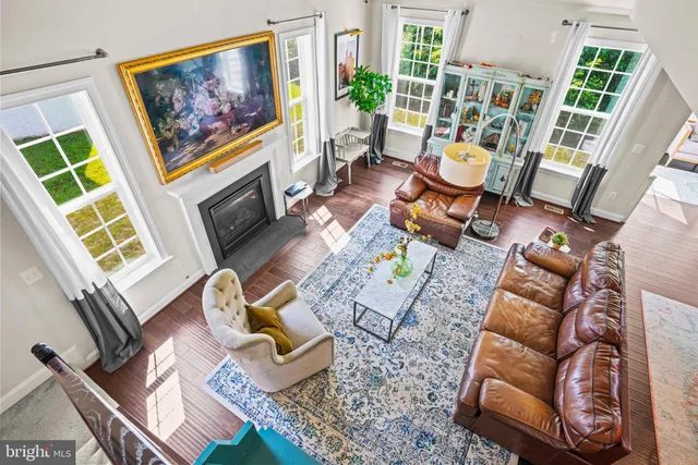 a living room with patio furniture and a wooden floor