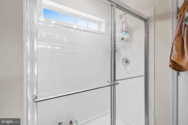 a bathroom with a glass shower door