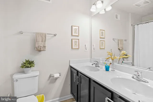a bathroom with a sink a toilet and mirror