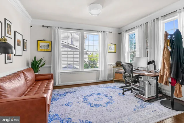 a living room with furniture window and a flat screen tv