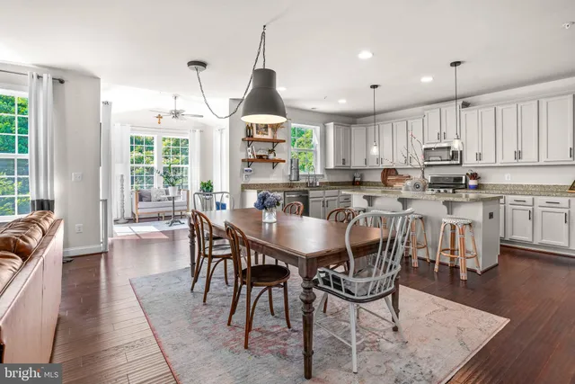 a view of a dining room with furniture window and wooden floor