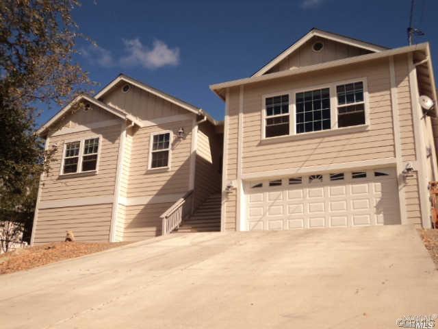 18932 Moon Ridge Road Hidden Valley Lake, CA 95467 - Photo 1 of 1 a front view of a house with a yard