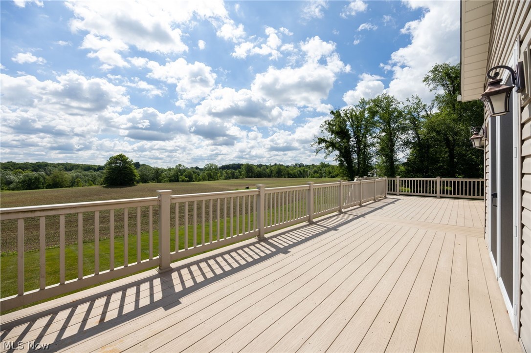 6925 River Styx Road Medina, OH 44256 - Photo 41 of 49 Expansive outdoor deck featuring composite decking, white railing, and exterior wall sconces