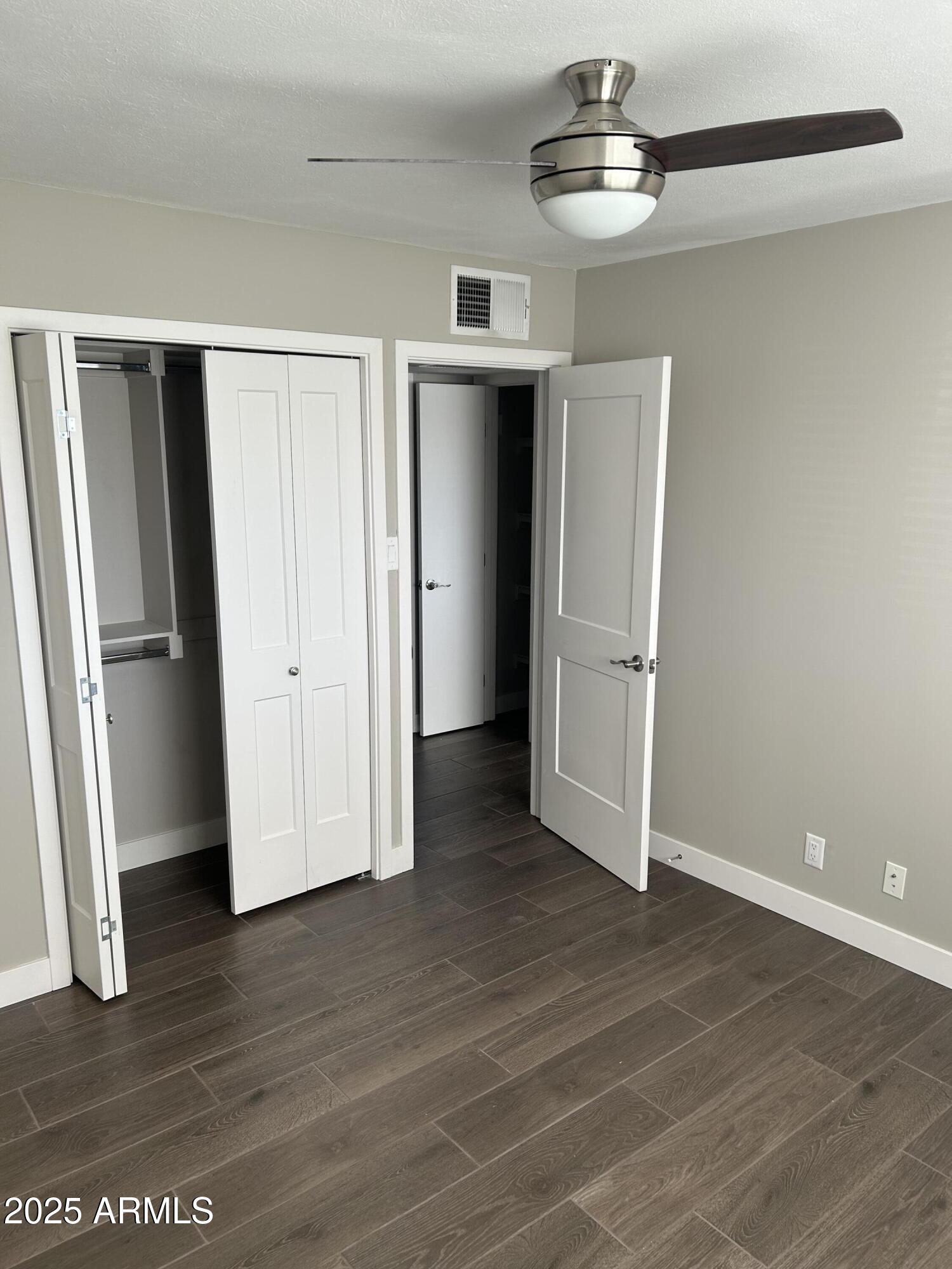 126 East Fillmore Street Tempe, AZ 85288 - Photo 13 of 20 a view of an empty room with wooden floor and a window