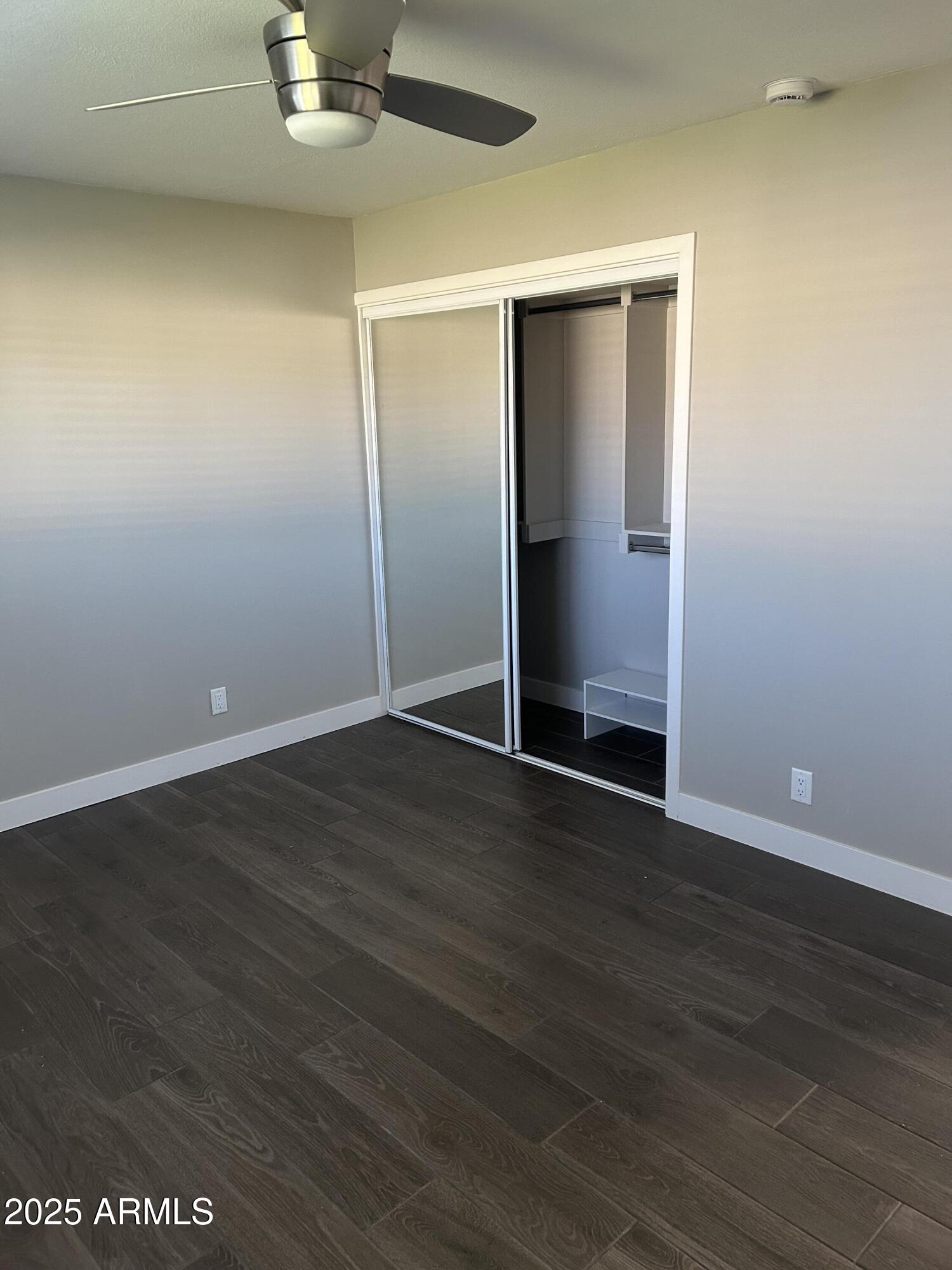 126 East Fillmore Street Tempe, AZ 85288 - Photo 16 of 20 an empty room with wooden floor and closet