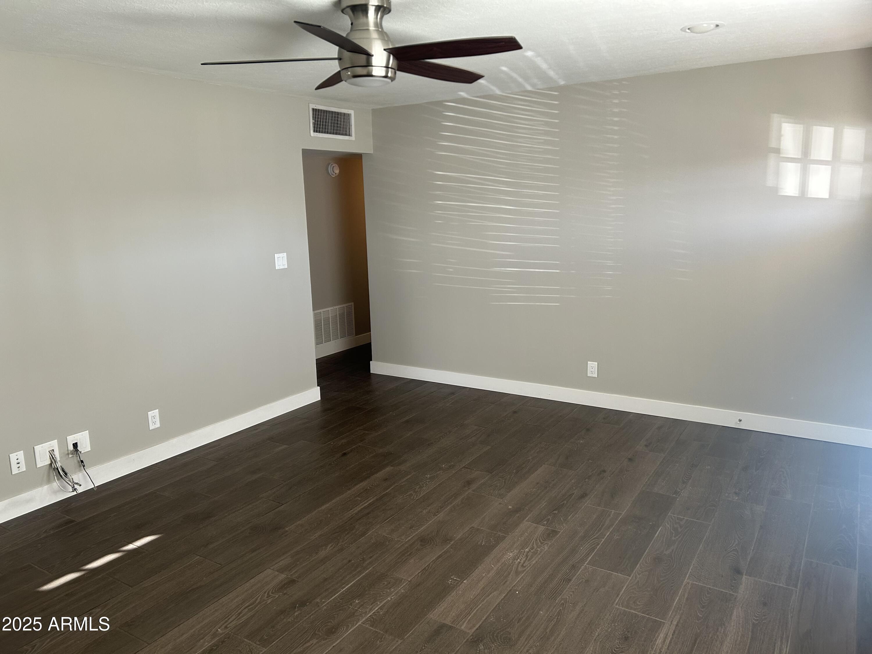 126 East Fillmore Street Tempe, AZ 85288 - Photo 4 of 20 an empty room with wooden floor and windows