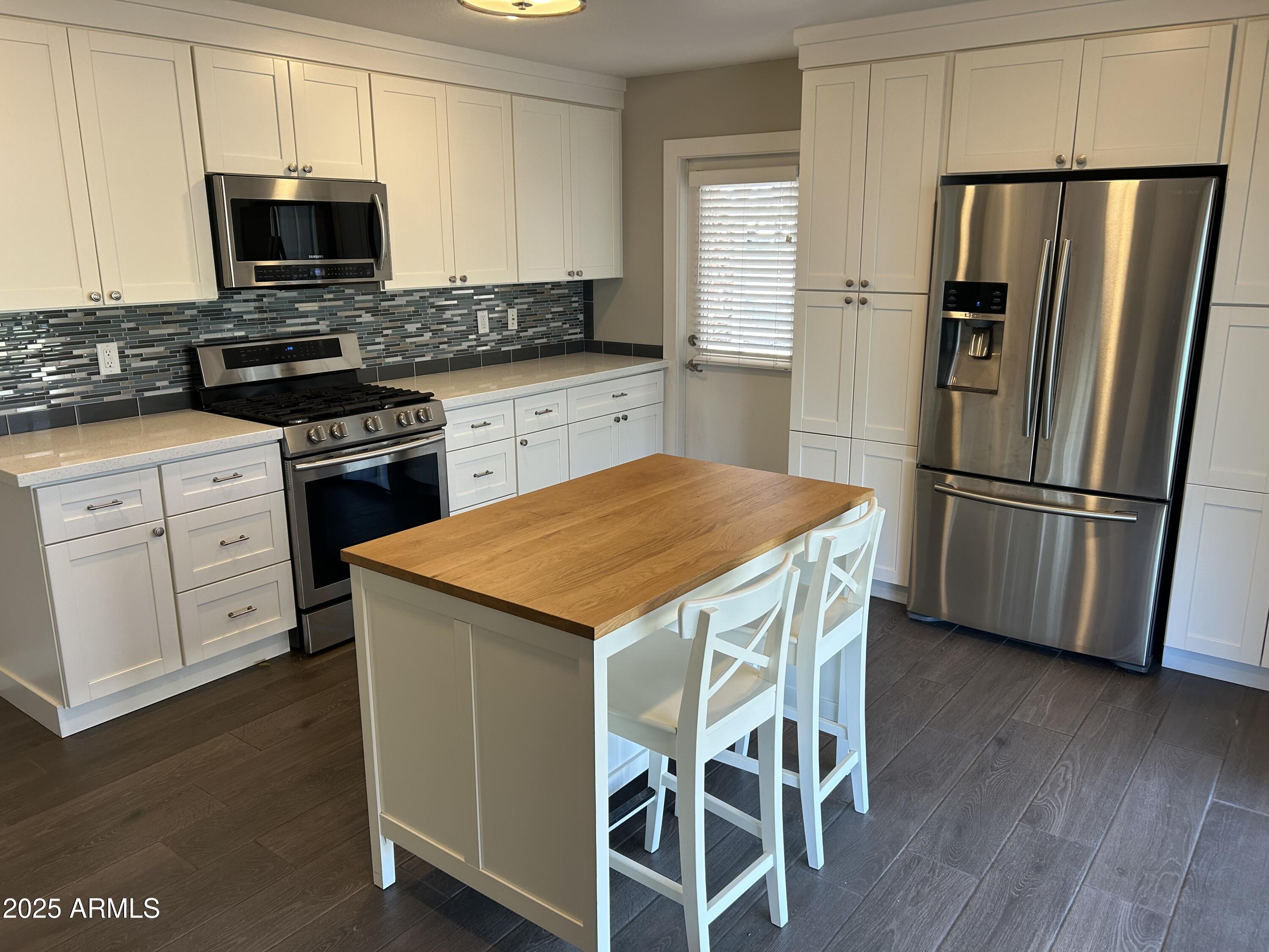 126 East Fillmore Street Tempe, AZ 85288 - Photo 5 of 20 a kitchen with stainless steel appliances a stove microwave and refrigerator