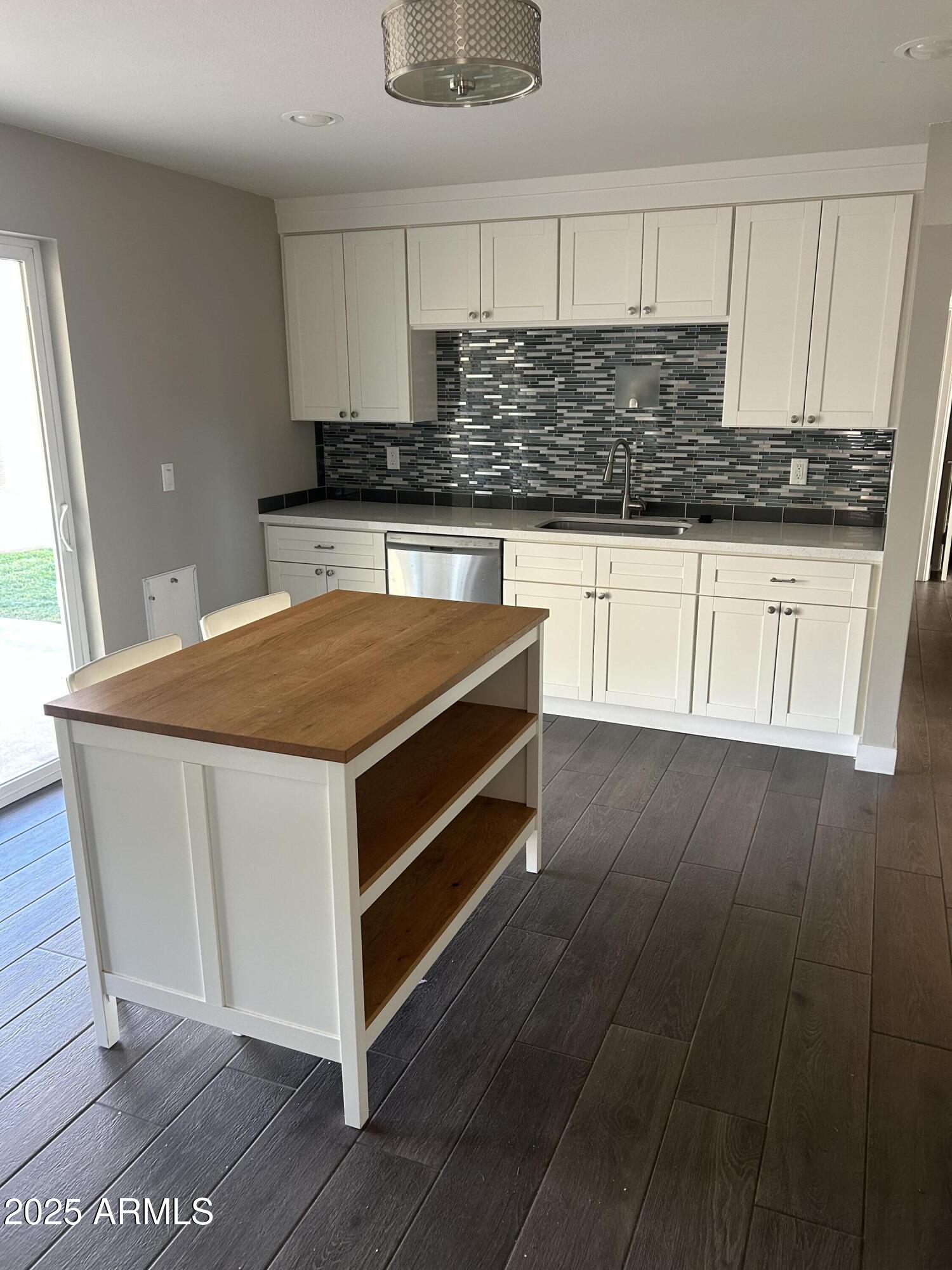 126 East Fillmore Street Tempe, AZ 85288 - Photo 6 of 20 a kitchen with stainless steel appliances granite countertop a stove a sink and a microwave