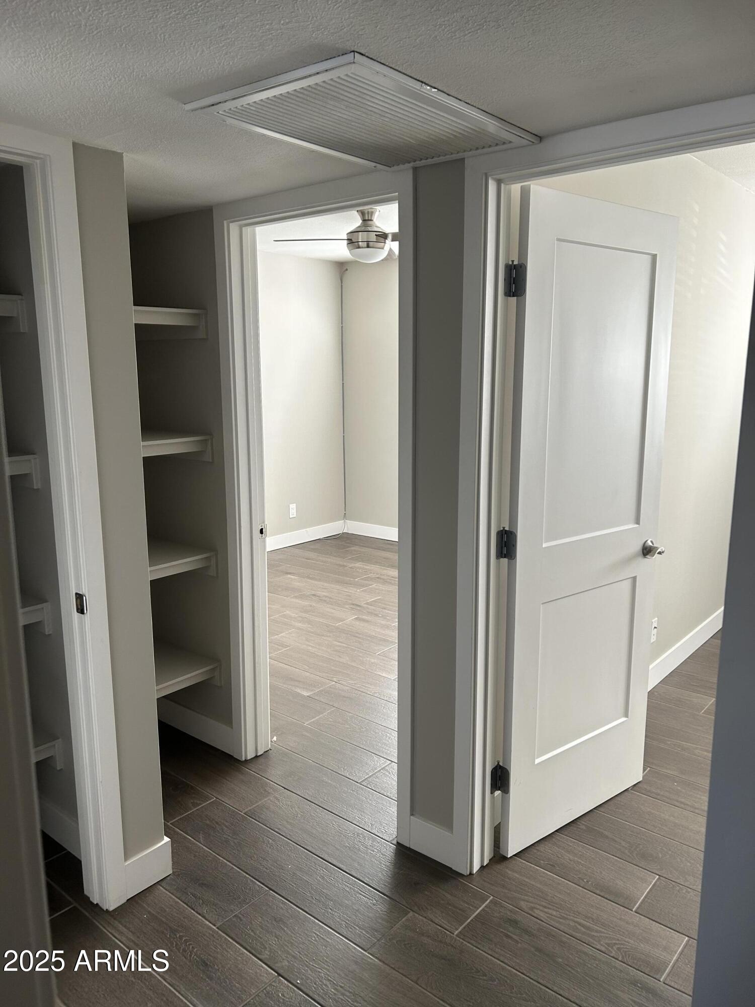 126 East Fillmore Street Tempe, AZ 85288 - Photo 9 of 20 a view of an empty room with wooden floor and closet