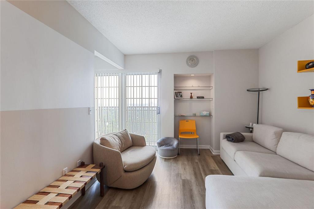 a living room with furniture and a floor to ceiling window