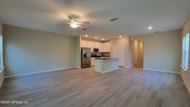a view of kitchen with refrigerator microwave and stove