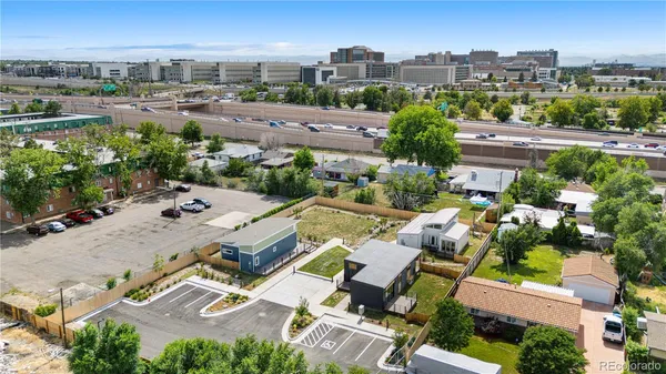 an aerial view of a house with garden space and street view