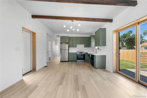 a view of a kitchen with a sink and a large window