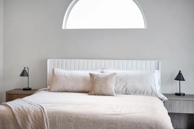 a bedroom with a bed and a lamp