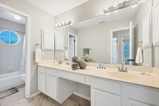 a bathroom with a double vanity sink mirror and double