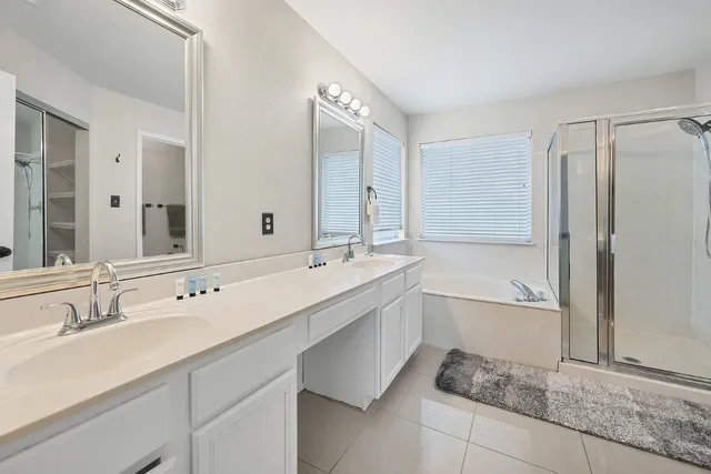 a bathroom with a tub sink and mirror