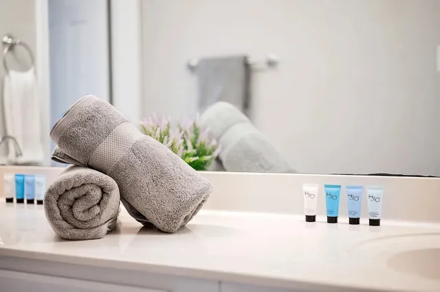 a bathroom with a granite countertop and white vanity