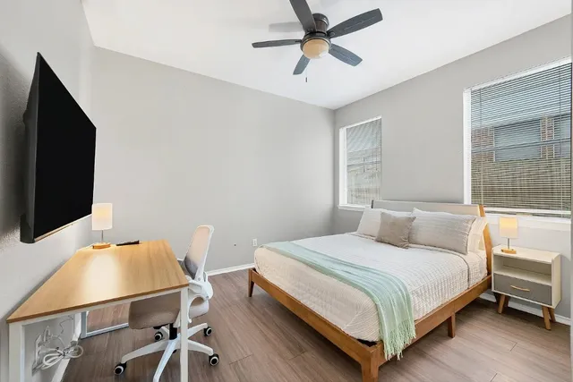 a bedroom with a bed and a flat screen tv