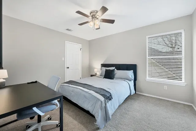 a bedroom with a bed and a window