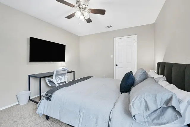 a bedroom with a bed and a flat screen tv