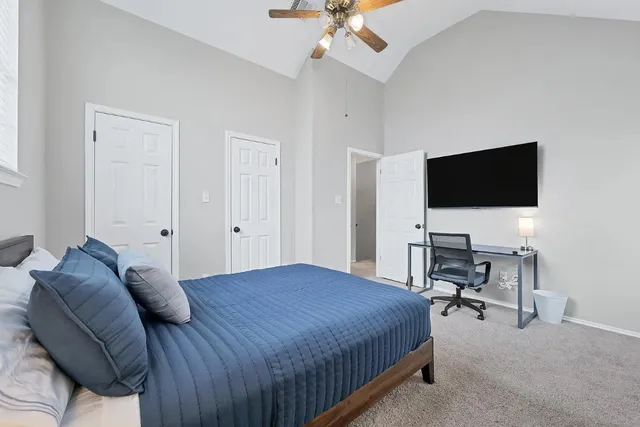 a bedroom with a bed and a flat screen tv