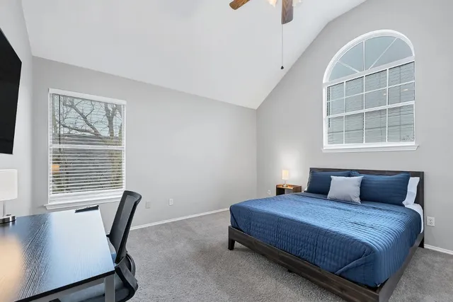 a bedroom with a bed and a window